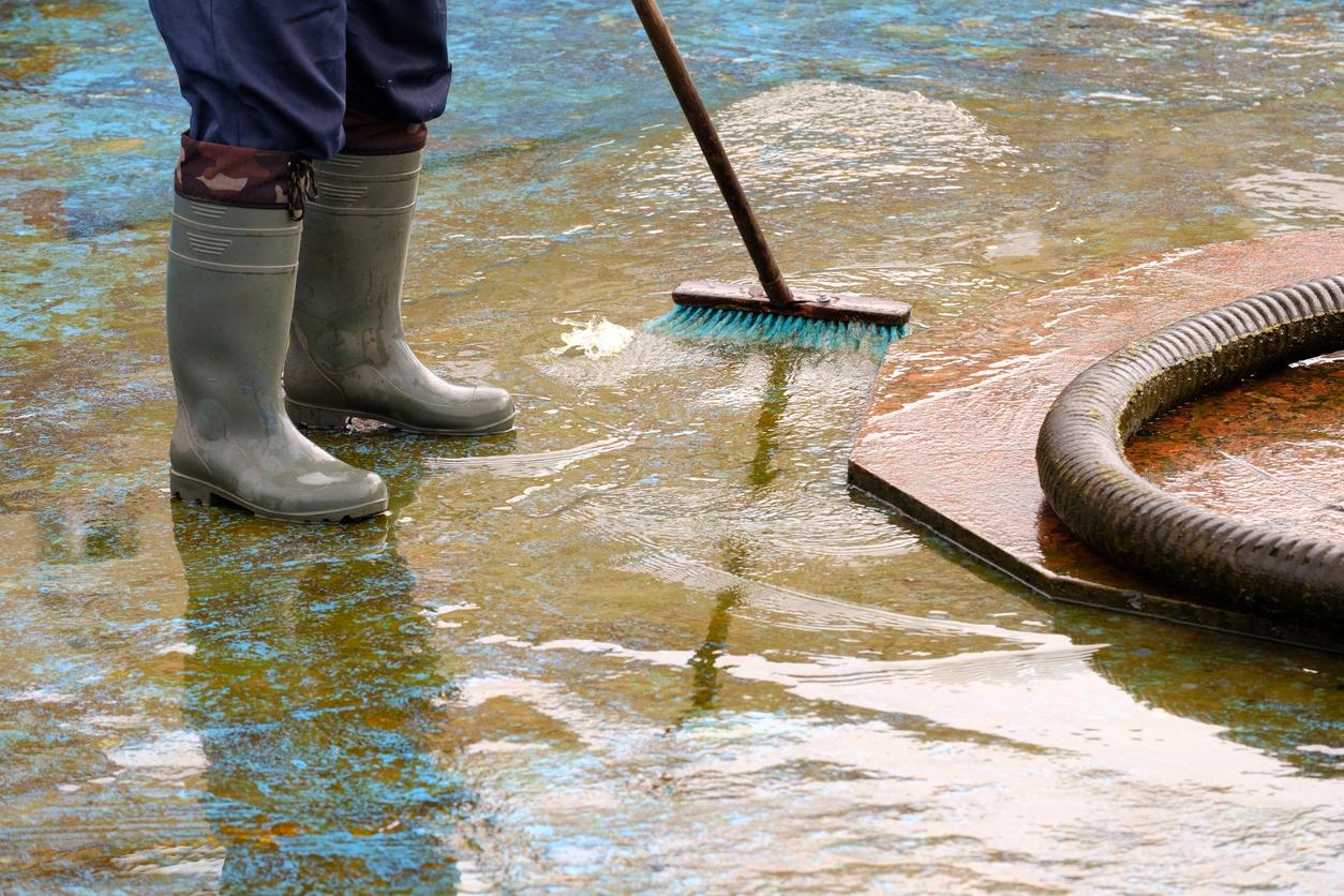 Person sweeping flooded area