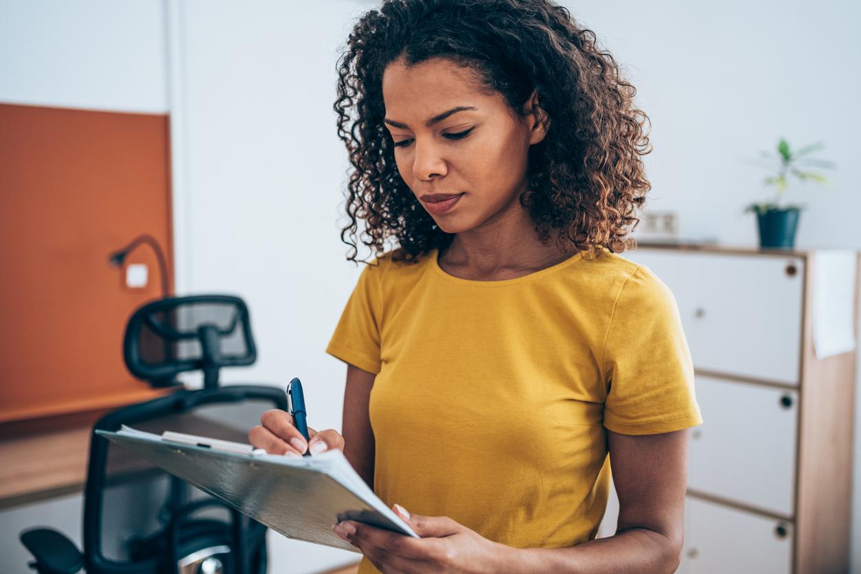 Woman looking at a clipboard