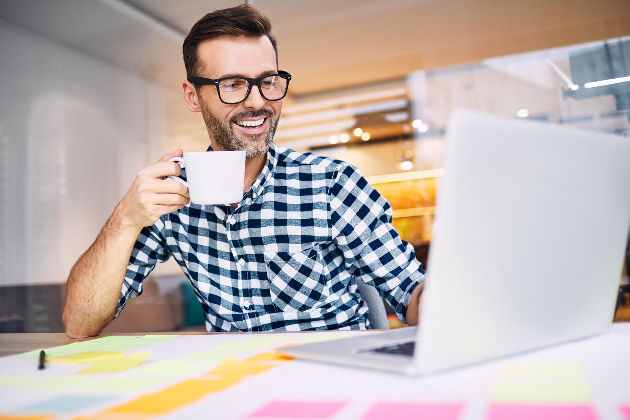Man with coffee on computer