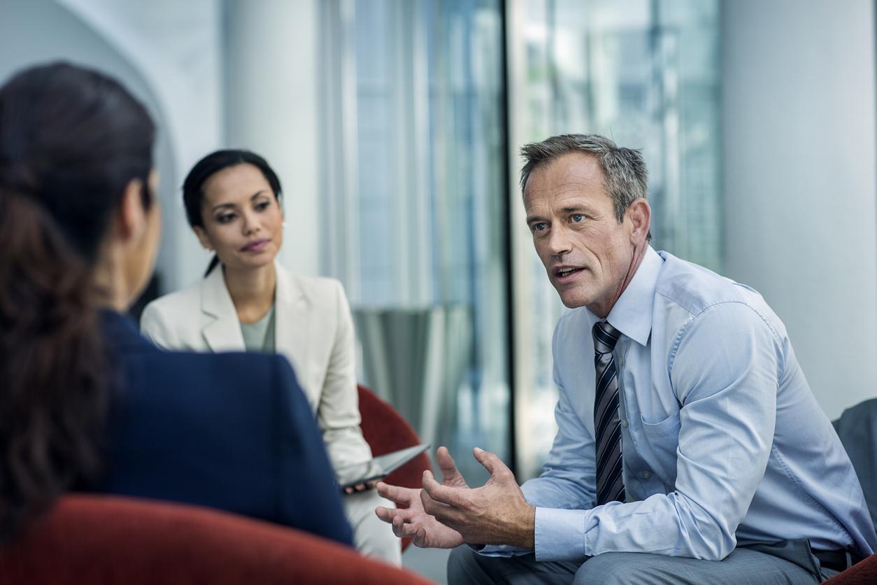 Three people in a meeting