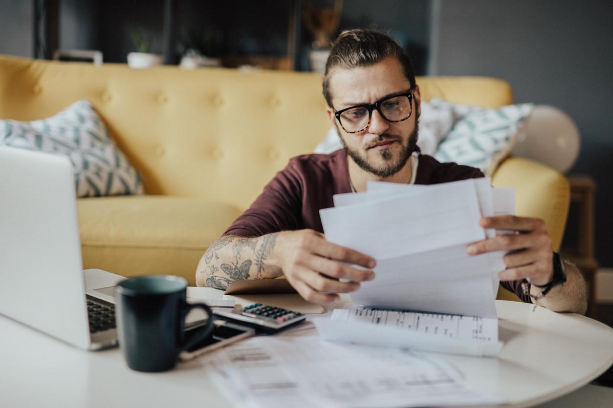 Worried man looking at documents