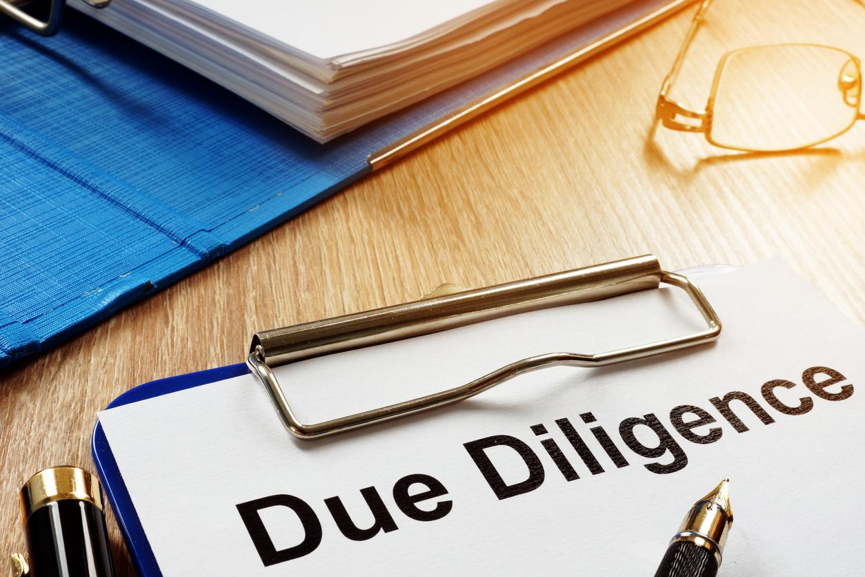 Document with title Due Diligence on a desk
