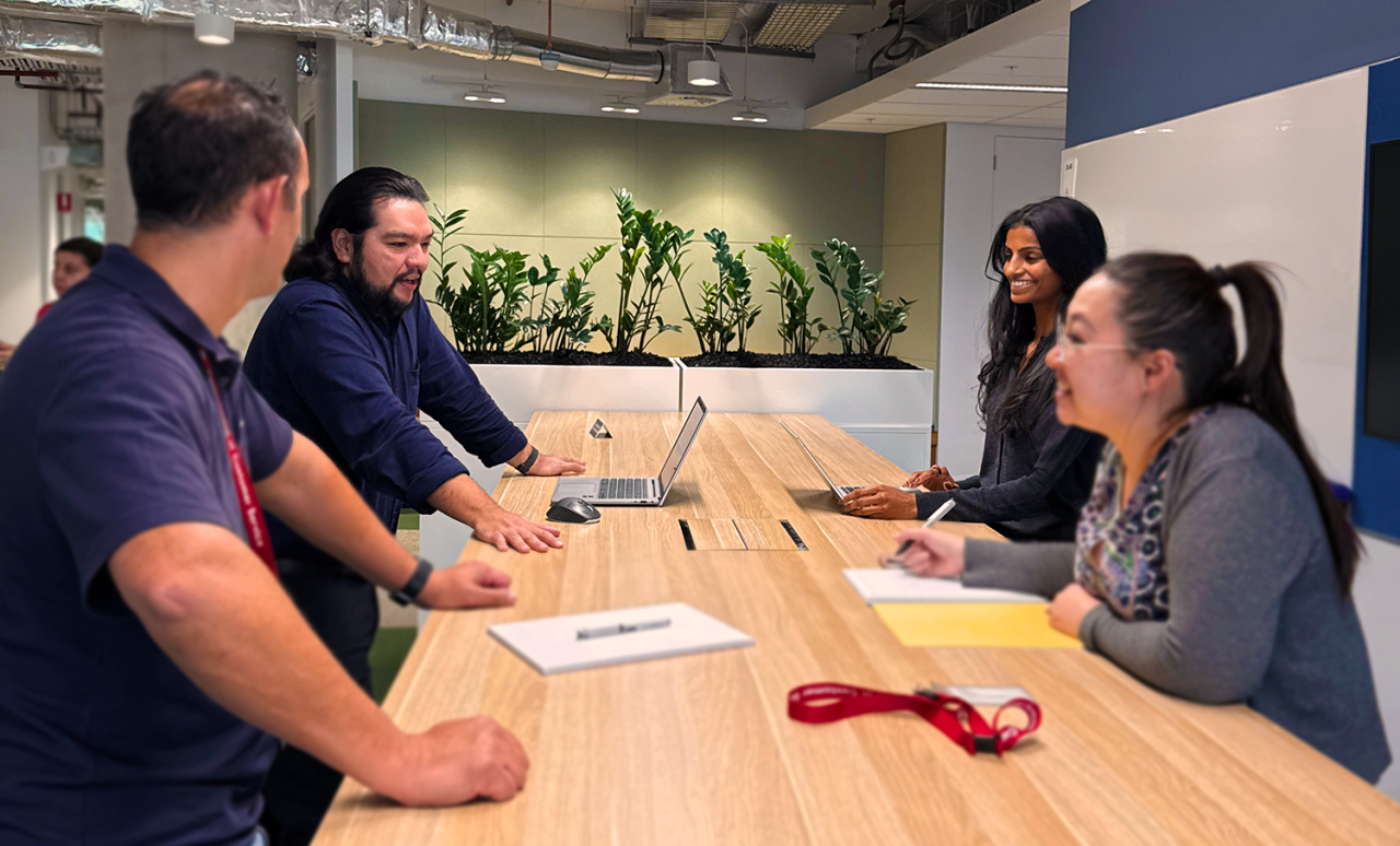 People talking around desk