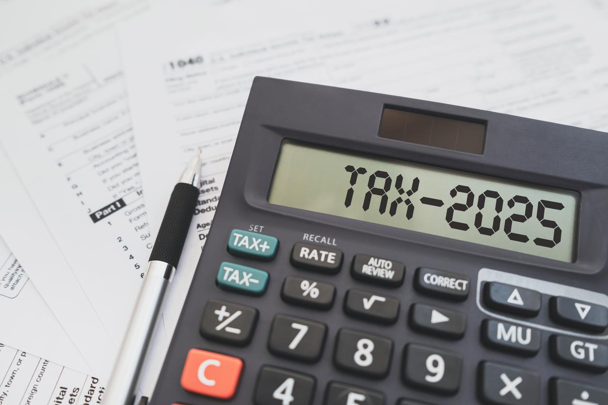 Text Tax 2025 on the calculator and taxes documents