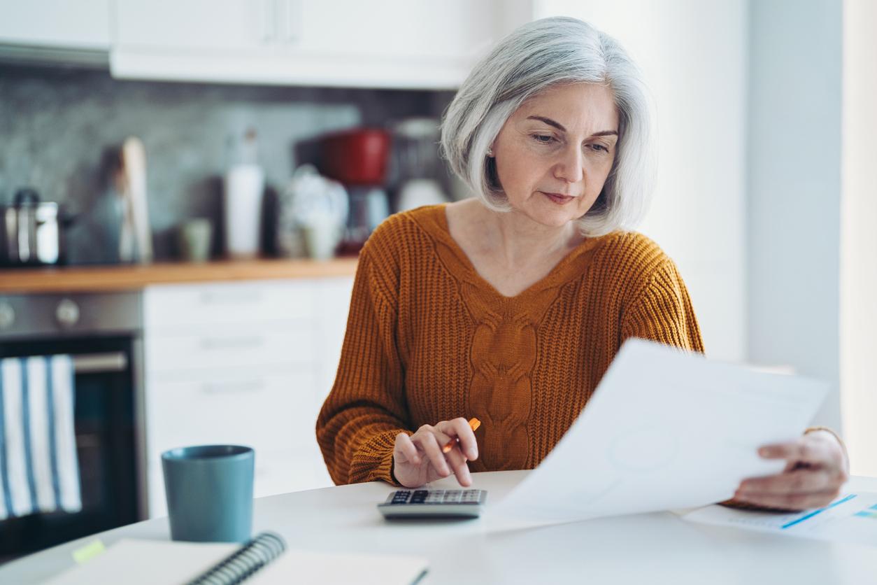 Mature woman calculating expenses